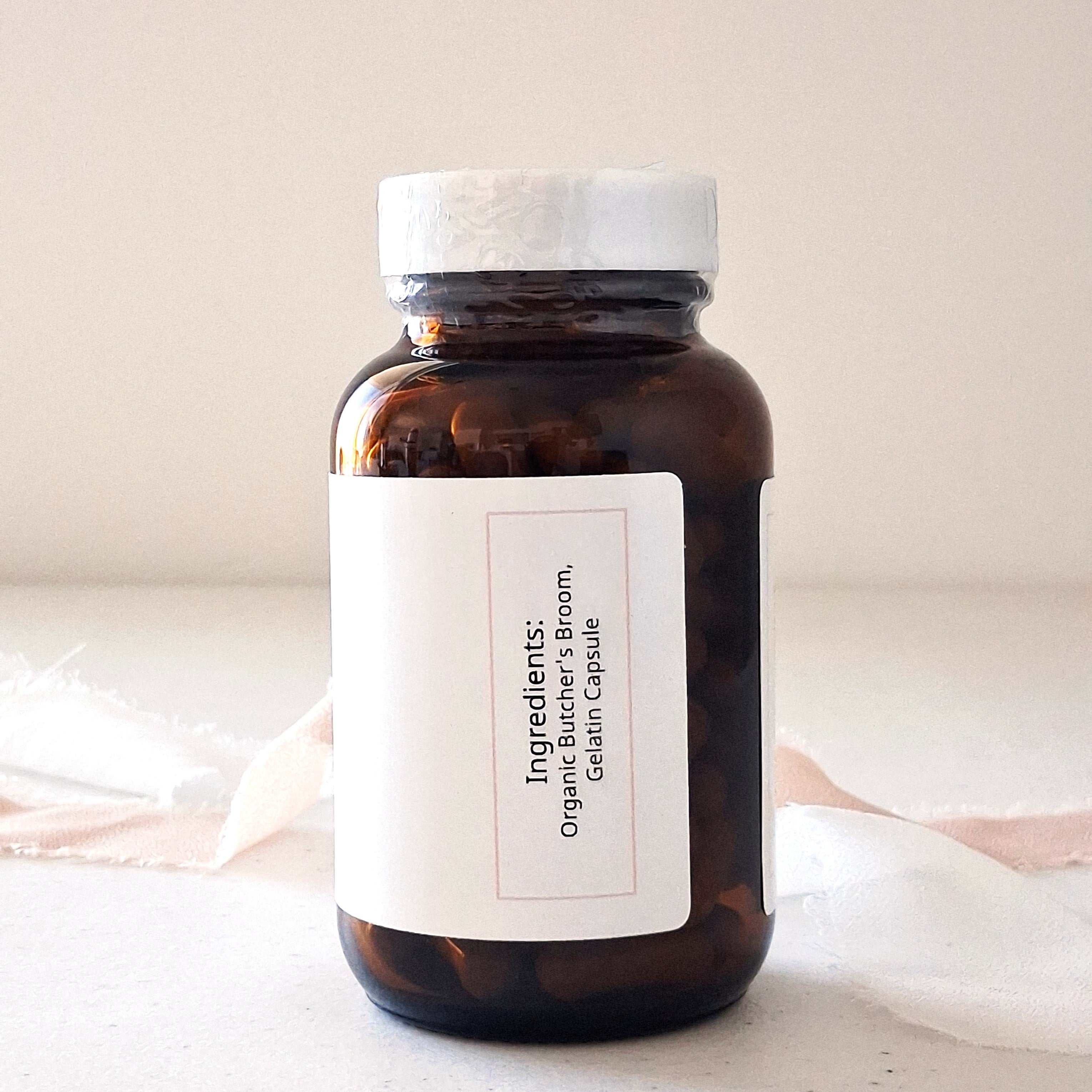 Brown glass bottle with white label on a light background