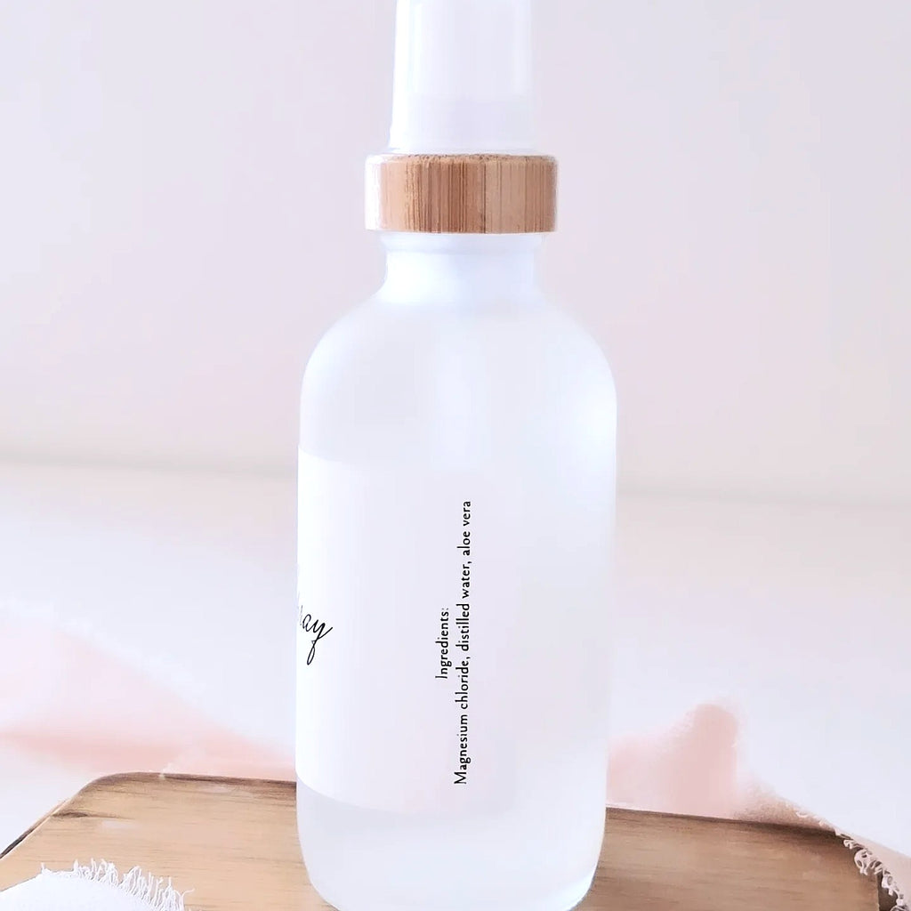 White bottle with a wooden cap on a light pink background